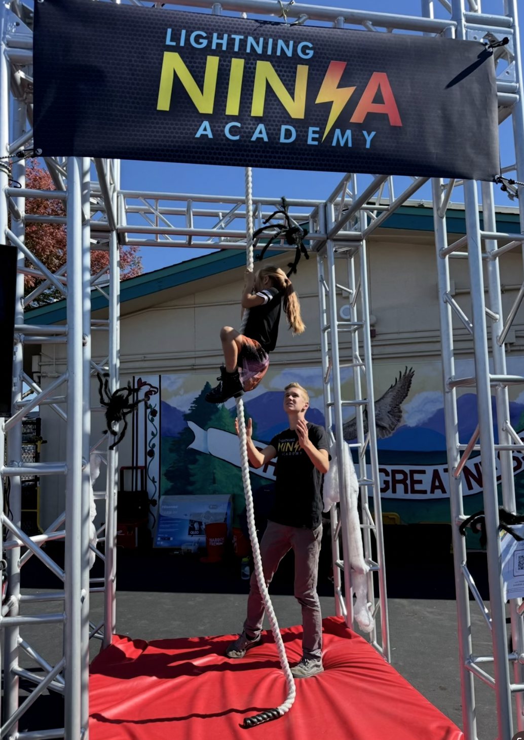 Kid balancing on a ninja obstacle during training